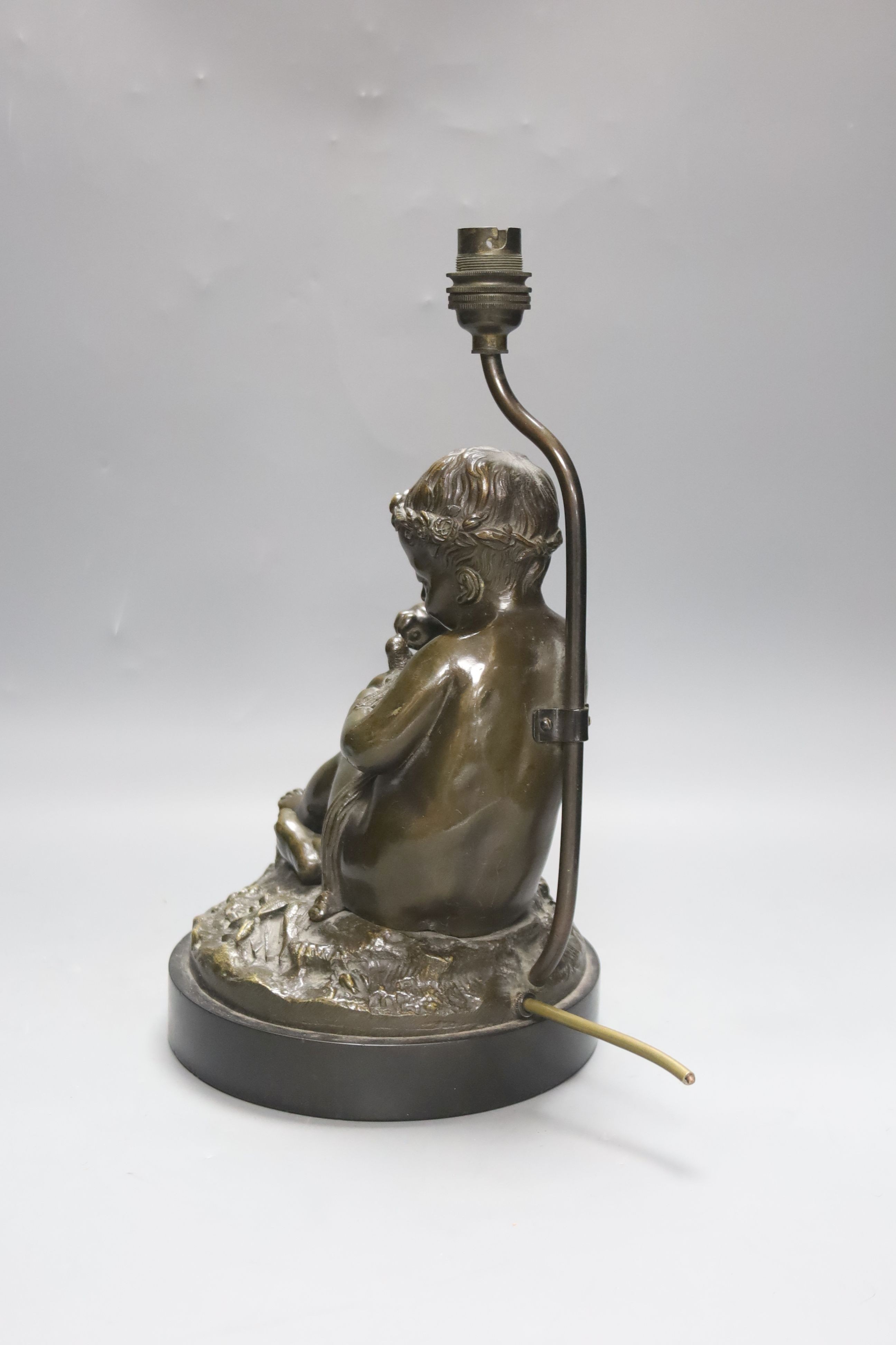 A late 19th century French bronze lamp base, putto and dove, 34cm total